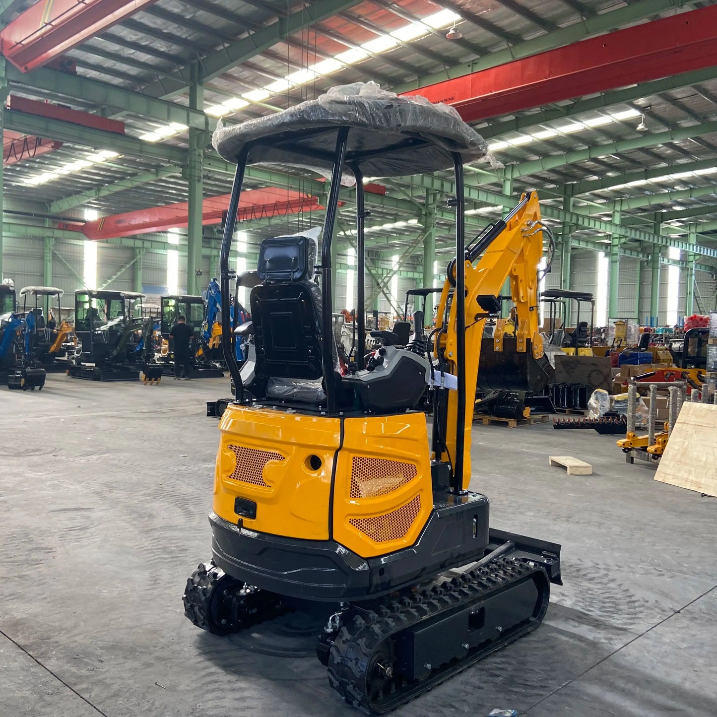 Small excavator with a capacity of 1.8 tons is used for free transportation of new Kubota engines for construction farms